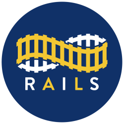RAILS Logo in Yellow and White Letters on Dark Blue Circle
