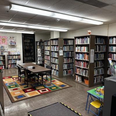 room with metal bookshelves and brown rectangular table