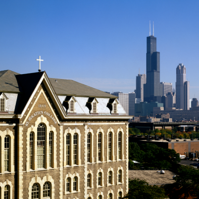 Photo of a historic school building against the Chicago skyline